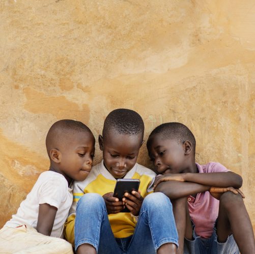 medium-shot-kids-looking-smartphone